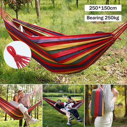 Colorful striped hammock with carrying strap in a forest setting, showing size and weight capacity.