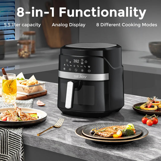 Black air fryer on a kitchen counter with food plates and a glass of juice, featuring text about its features.